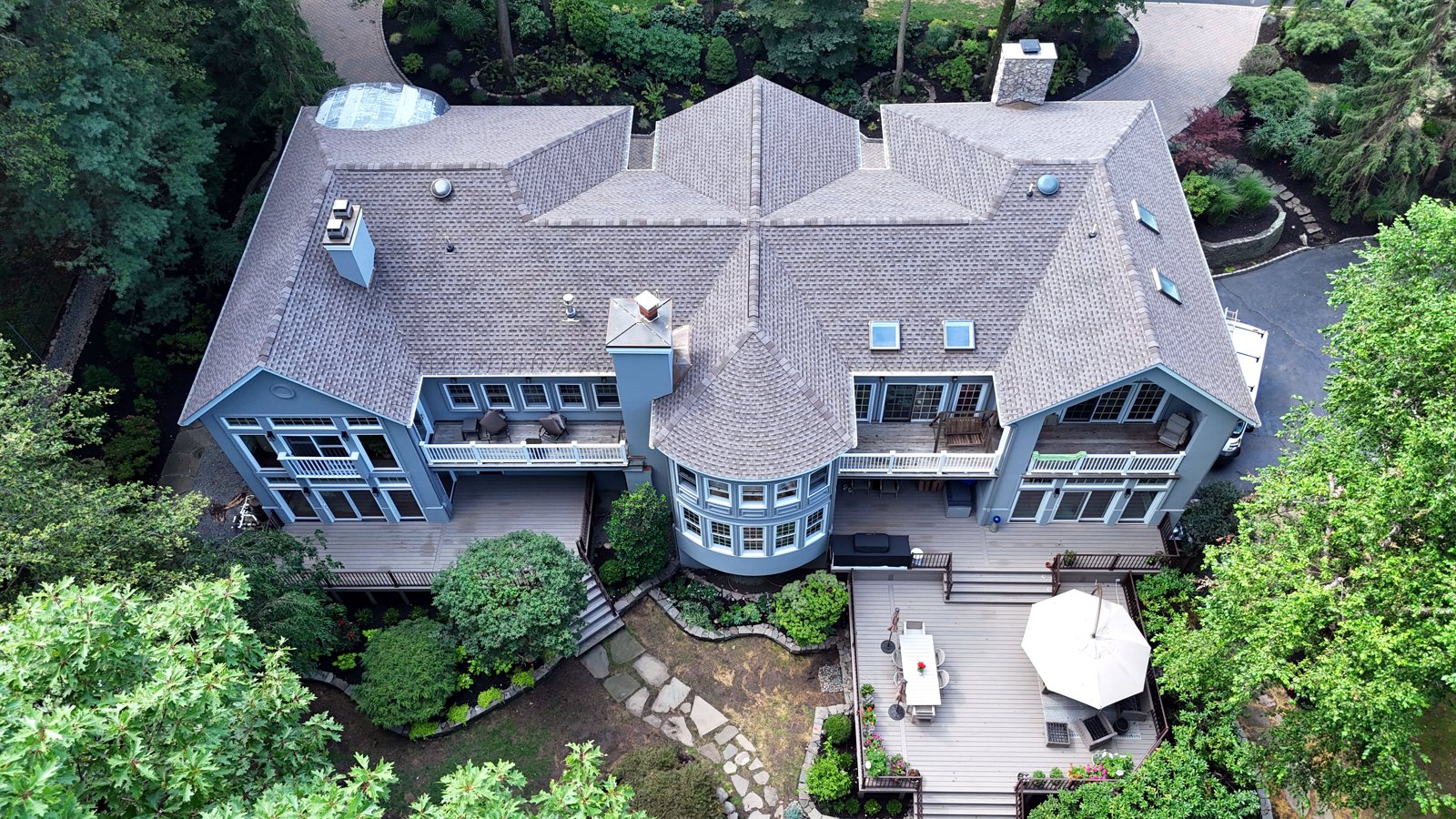 Whole-home exterior renovation with new roof, stucco and Trex deck