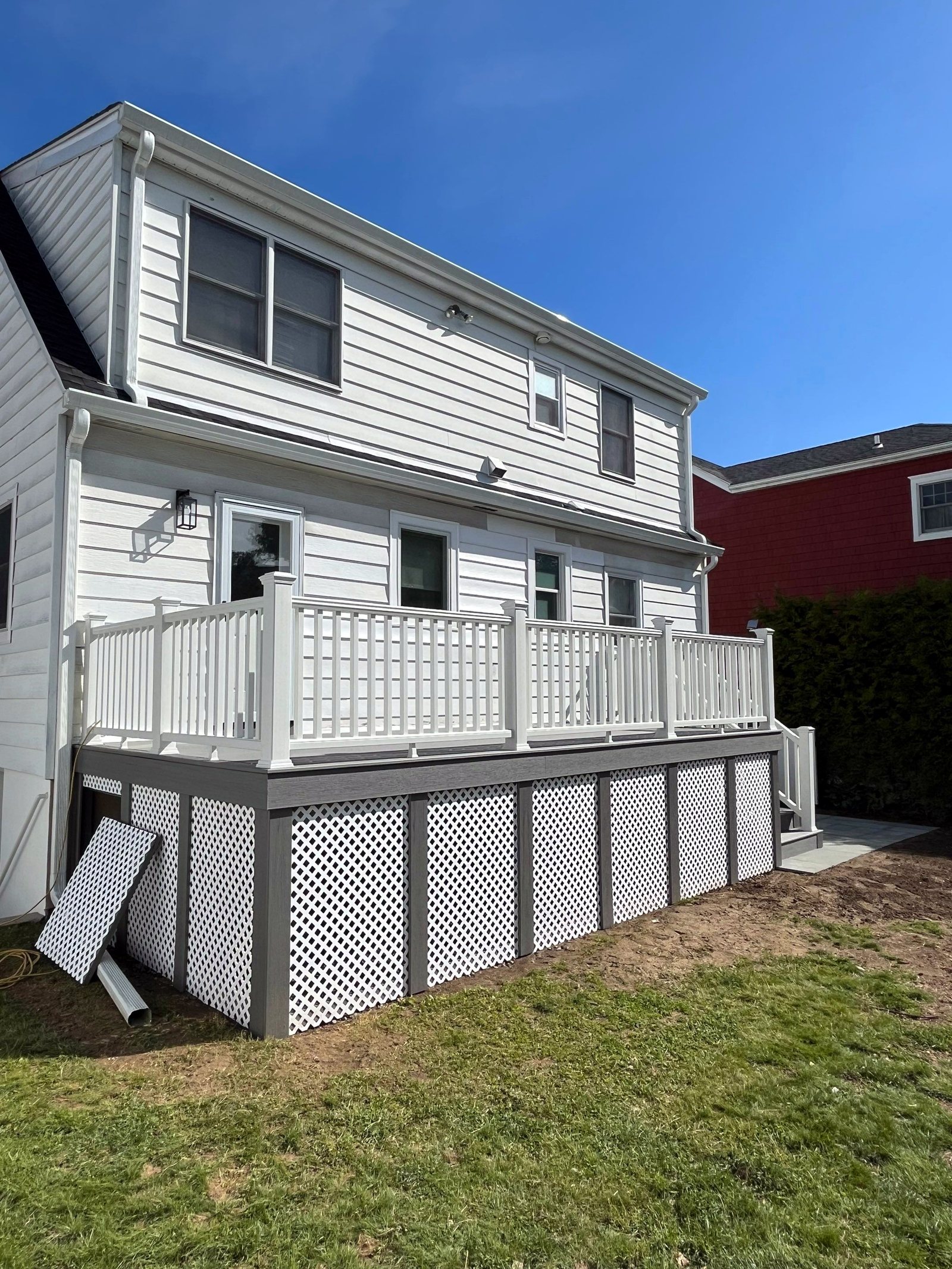 Custom Trex Select composite deck with white railings and lattice skirt